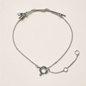 H&M Conscious Exclusive recycled silver bracelet with flower detail.